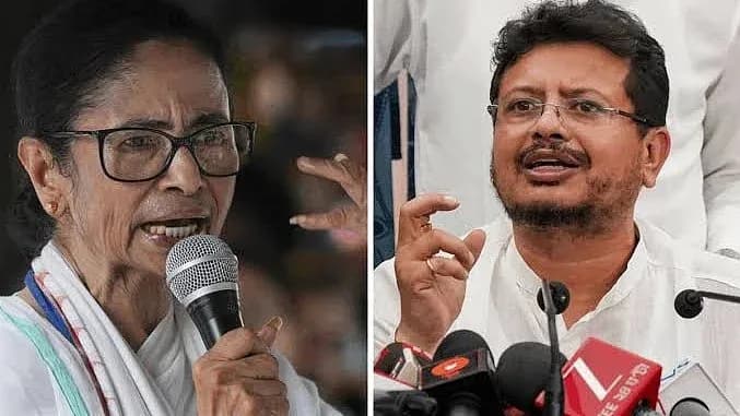 ایک خاتون مائیکرو فون پر بات کر رہی ہے اور ایک مرد ہاتھ کے اشارے سے بات کر رہا ہے۔
